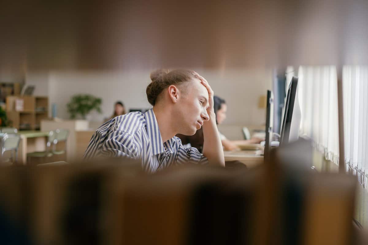 man experiencing academic stress