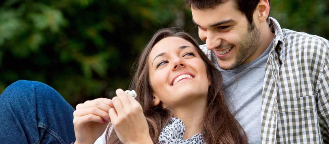 Close up portrait of attractive young couple in love outdoors.