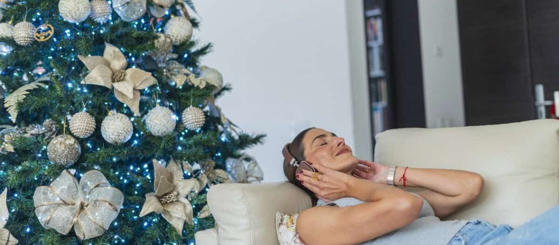 Latin woman is inside her house enjoying her moments alone in the living room of her house