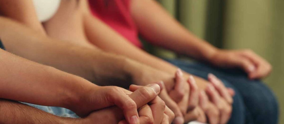 Young people holding hands close up