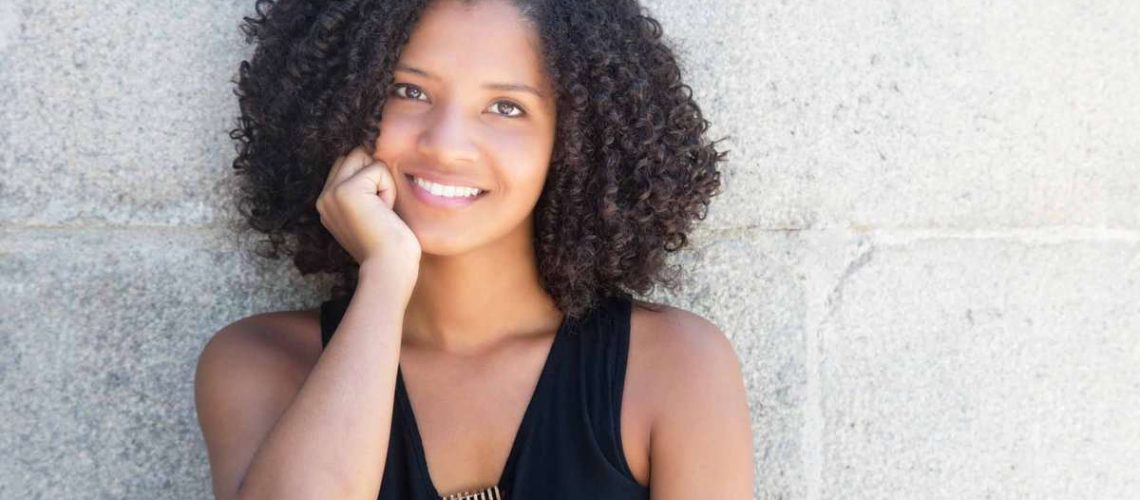 Happy african american woman with curly black hair