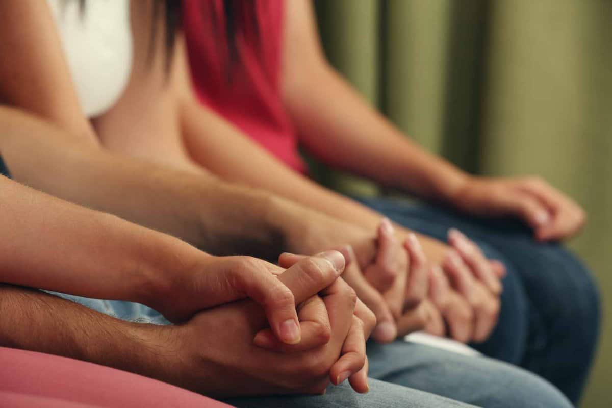 Young people holding hands close up