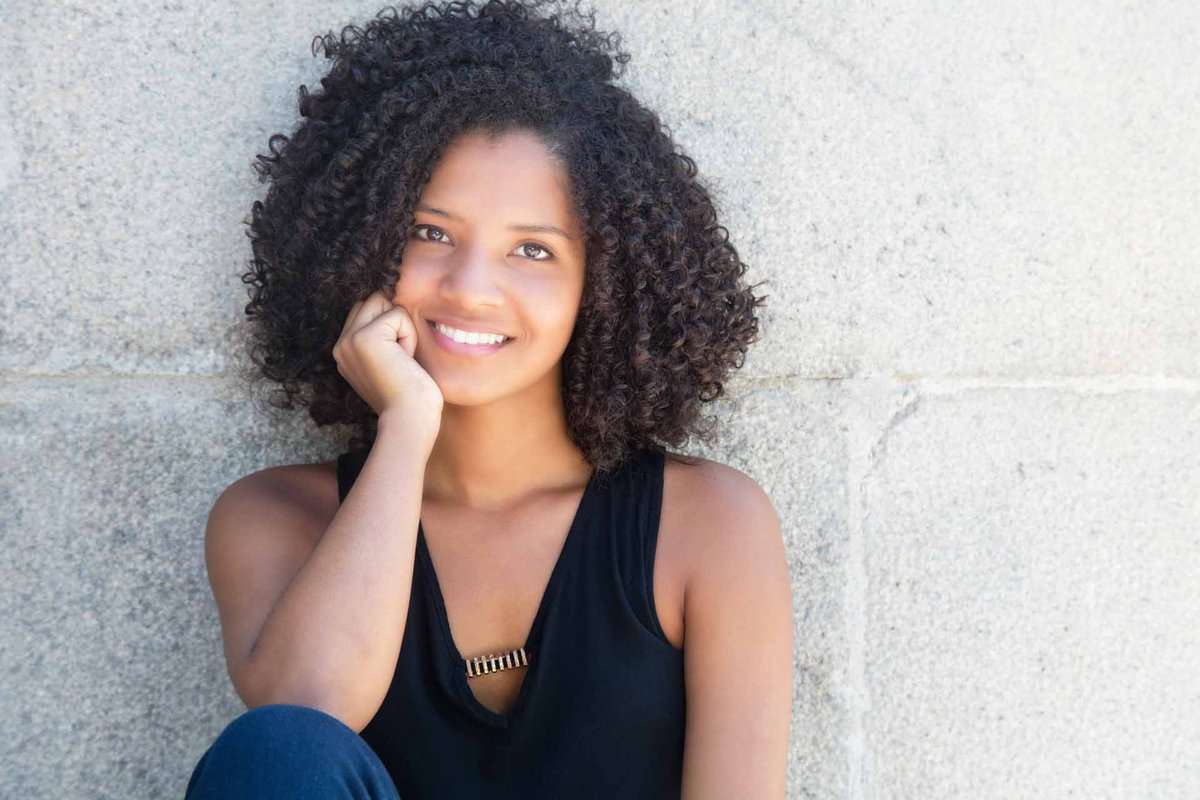 Happy african american woman with curly black hair